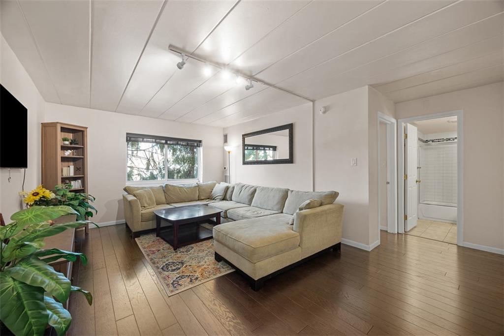 5 Bayard Road, Unit 121 Pittsburgh, PA 15213 - Photo 11 of 24 The large living room is an open, airy space that feels both spacious and cozy, perfect for relaxation and entertaining. The ceilings are high, with recessed lighting elegantly installed throughout, offering a soft, even illumination that can be adjusted to set the mood according to your desires.