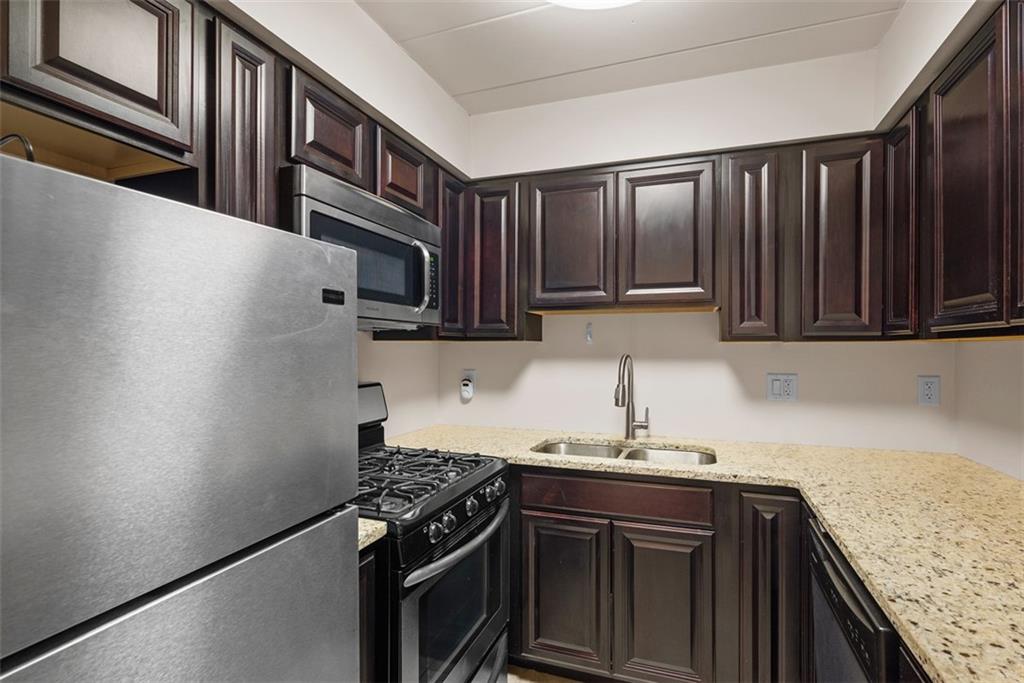 5 Bayard Road, Unit 121 Pittsburgh, PA 15213 - Photo 9 of 24 The cabinets, made of rich materials like deep walnut, espresso, or charcoal, create a sense of warmth and luxury, offering a striking contrast to lighter-colored countertops and walls.