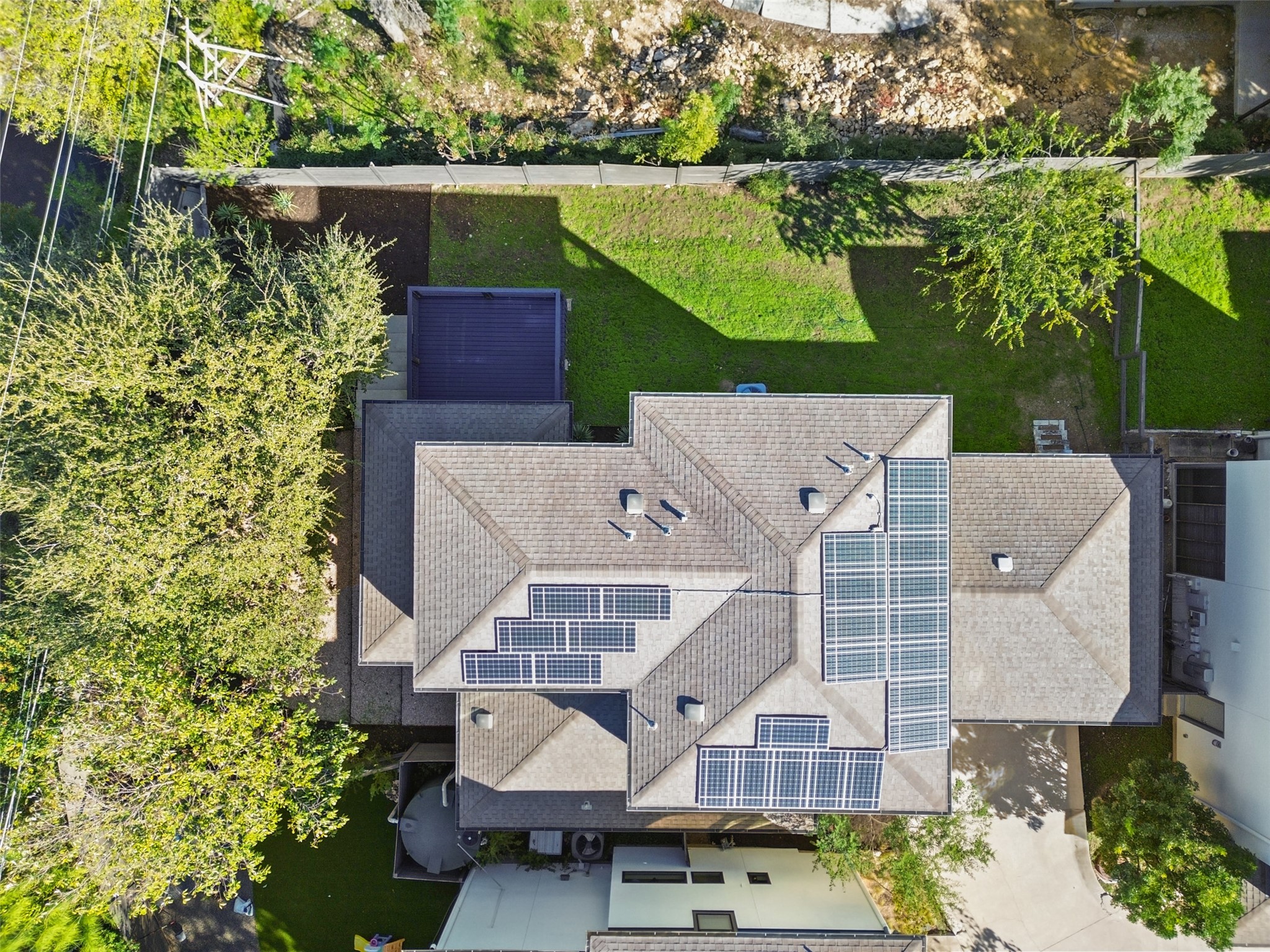 1303 Azie Morton Road, Unit 6 Austin, TX 78704 - Photo 16 of 40 View of extensive array of rooftop solar panels strategically installed across several sections of the pitched roof, highlighting the property's commitment to energy efficiency and reduced utility costs.