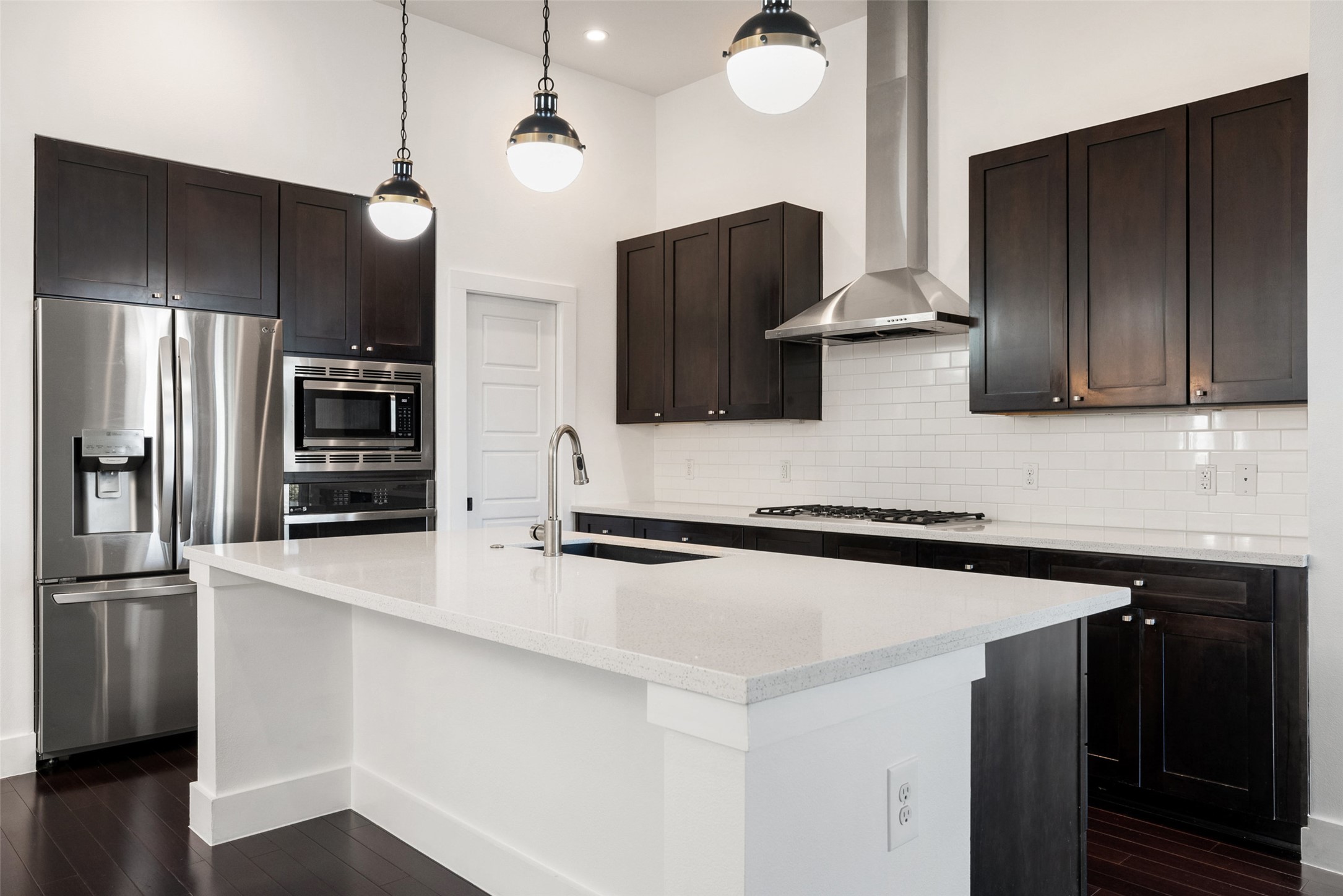 1303 Azie Morton Road, Unit 6 Austin, TX 78704 - Photo 22 of 40 Kitchen with stainless steel appliances, dark wood-style flooring.