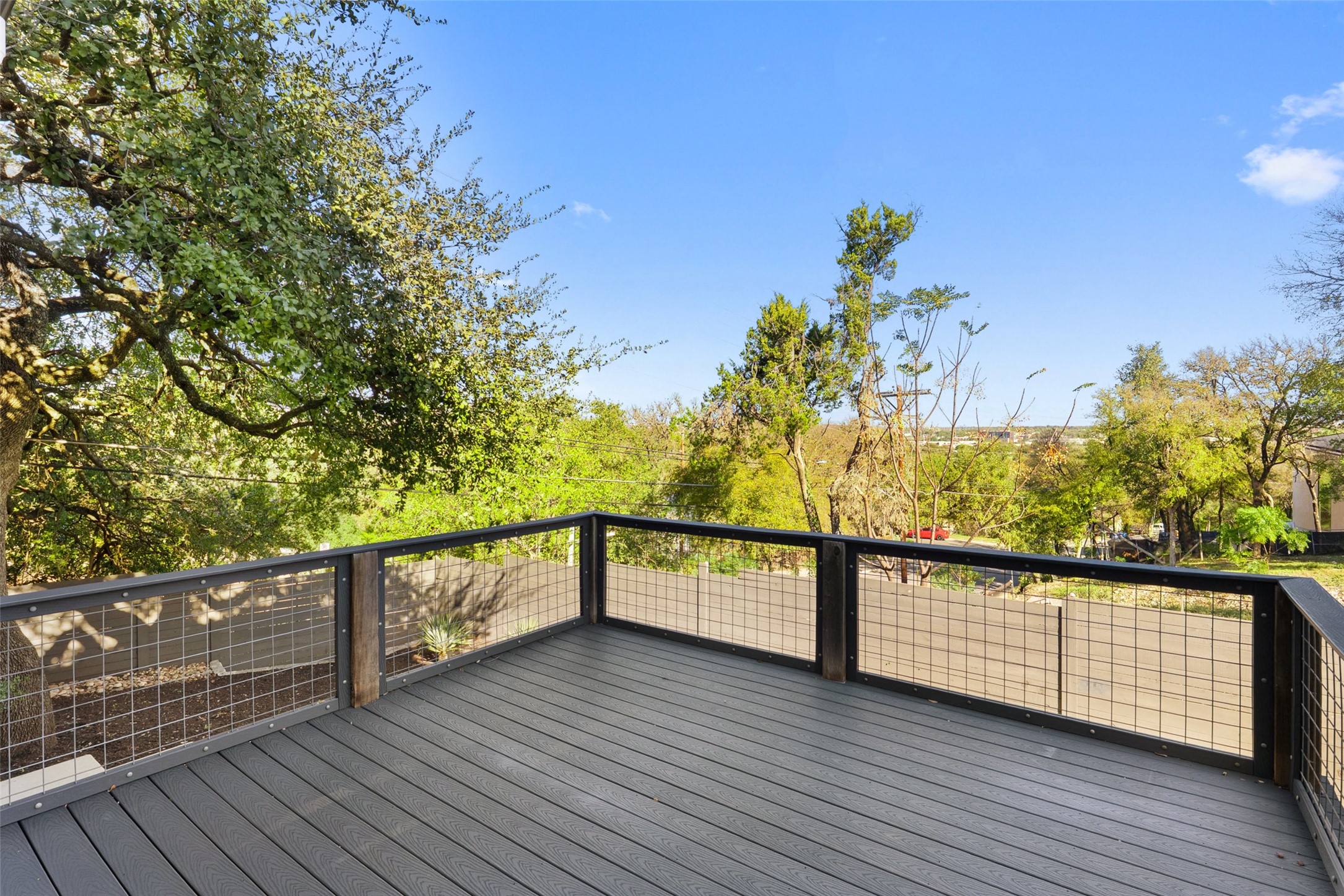 1303 Azie Morton Road, Unit 6 Austin, TX 78704 - Photo 9 of 40 This photo features an upper-level deck designed for enjoying the scenic, tree-filled views of the Zilker Park and Barton Springs area.