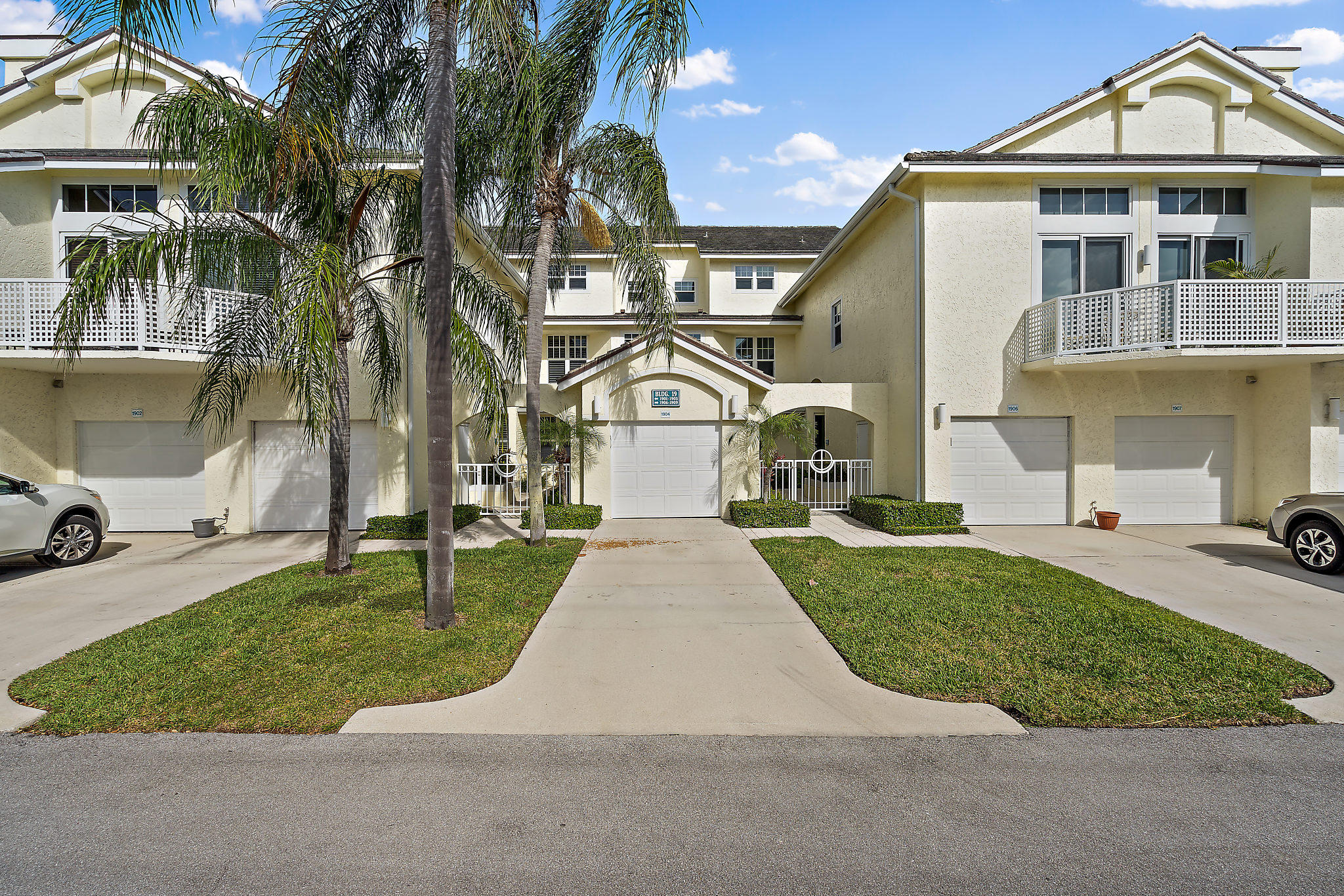 1906 Mainsail Circle Jupiter, FL 33477 - Photo 2 of 34 a front view of a house with a yard and trees