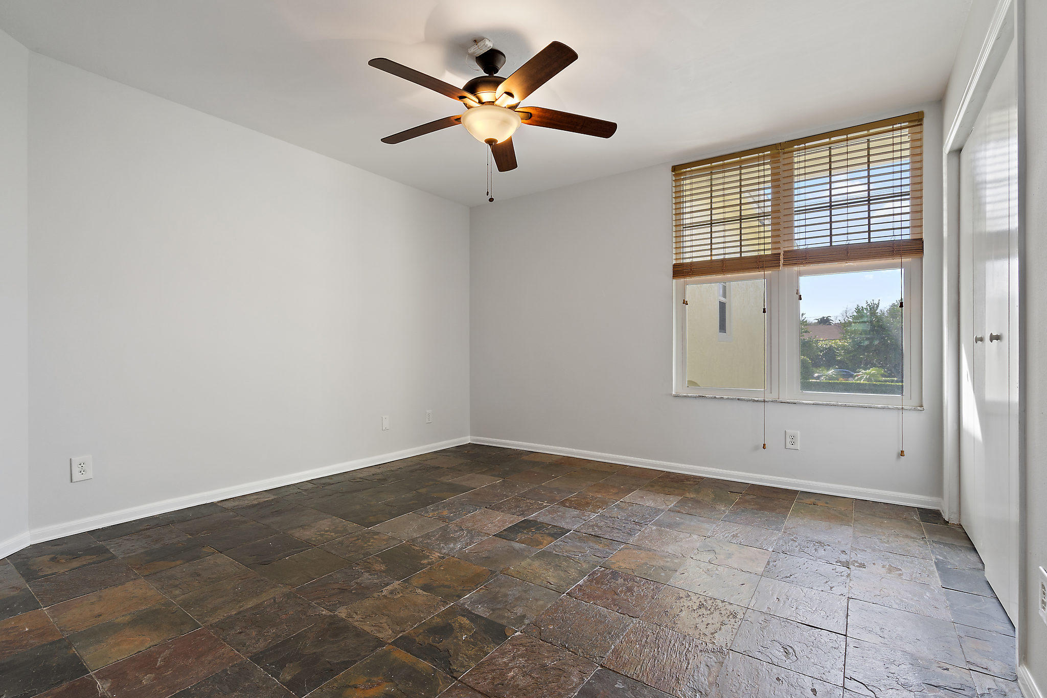 1906 Mainsail Circle Jupiter, FL 33477 - Photo 12 of 34 an empty room with windows and ceiling fan