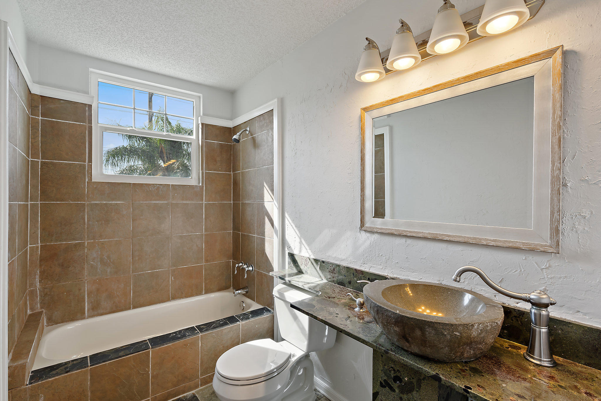 1906 Mainsail Circle Jupiter, FL 33477 - Photo 14 of 34 a bathroom with a sink a toilet and bathtub