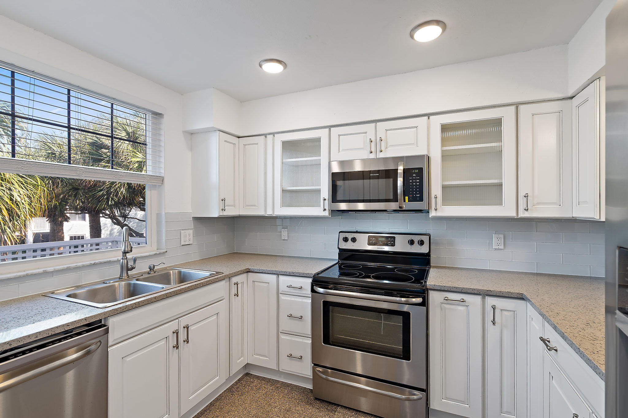 1906 Mainsail Circle Jupiter, FL 33477 - Photo 7 of 34 a kitchen with stainless steel appliances a stove microwave and sink