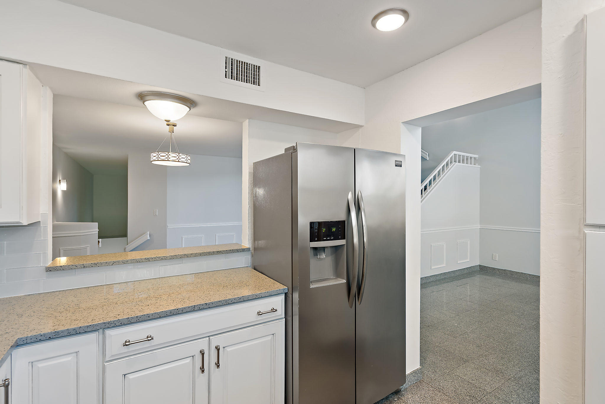 1906 Mainsail Circle Jupiter, FL 33477 - Photo 8 of 34 a modern kitchen with stainless steel appliances granite countertop a refrigerator and a sink