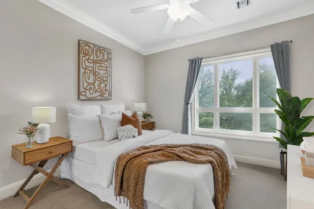 a bedroom with bed and a window