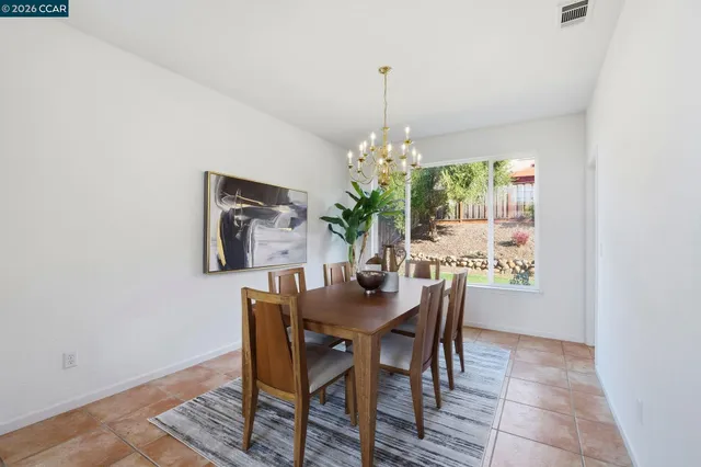 a view of a dining room with furniture and chandelier