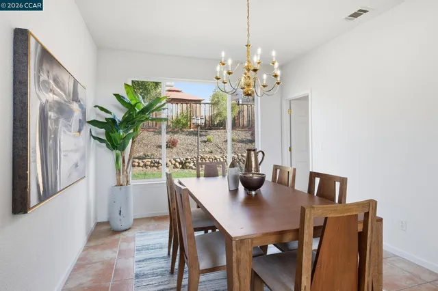 a view of a dining room with a table and chairs