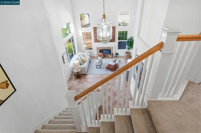 a living room with furniture a fireplace and a large window