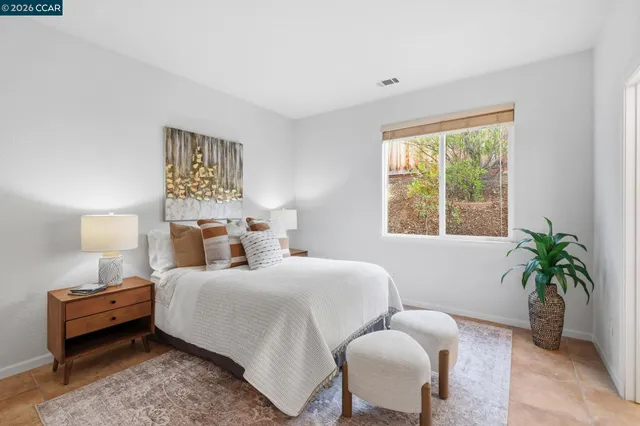 a bedroom with a bed and window