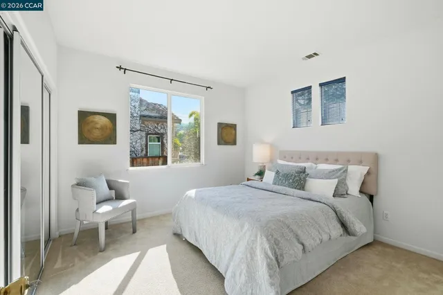 a bathroom with double vanity sinks a mirror and a shower