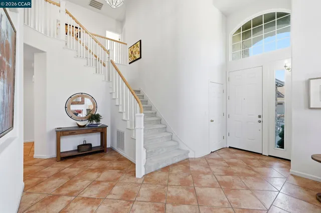 a view of an entryway with wooden floor and a front door