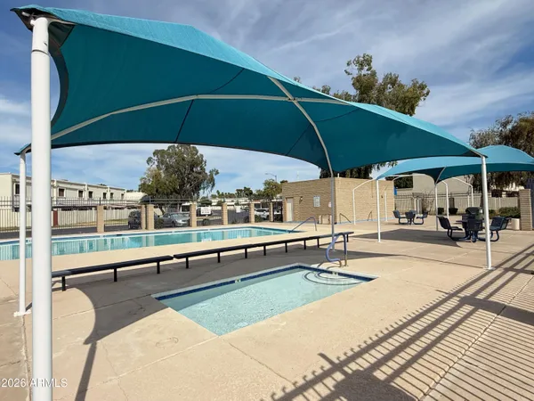 a view of a house with swimming pool and sitting area