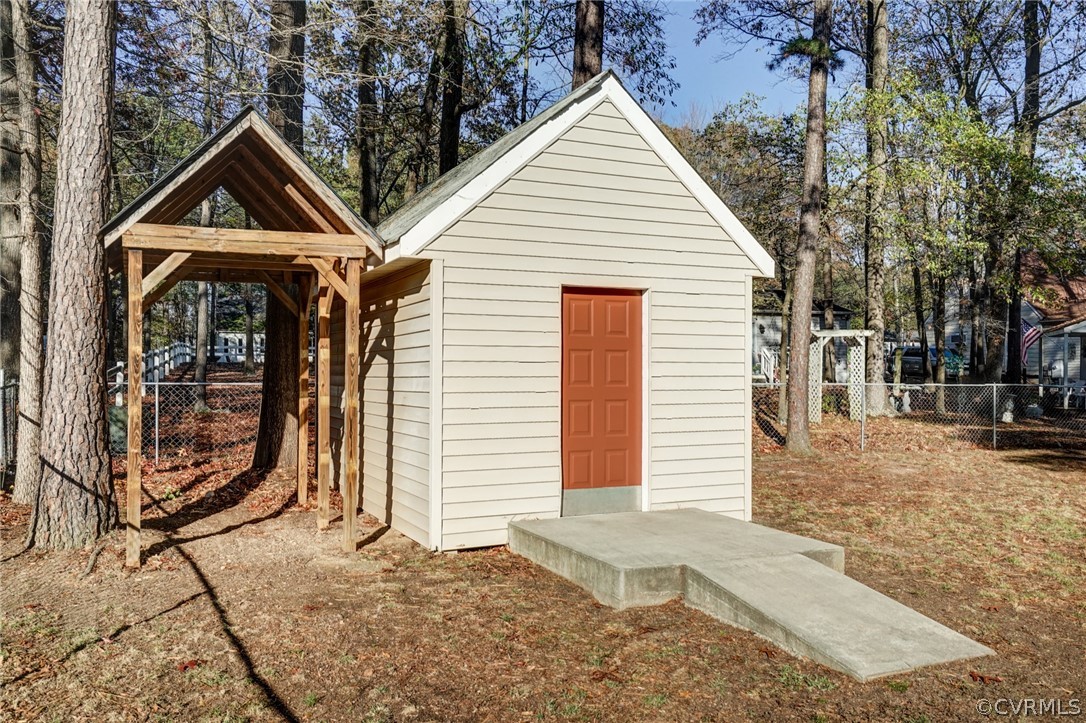5506 Linda Road Sandston, VA 23150 - Photo 37 of 44 Custom Built 10 x 15 Shed - Vinyl Siding , Door Freshly Painted, Ramp for Easy Access - Also has an attic storage space with pull down steps and workbench area! Plus additional covered storage for outdoor equipment!