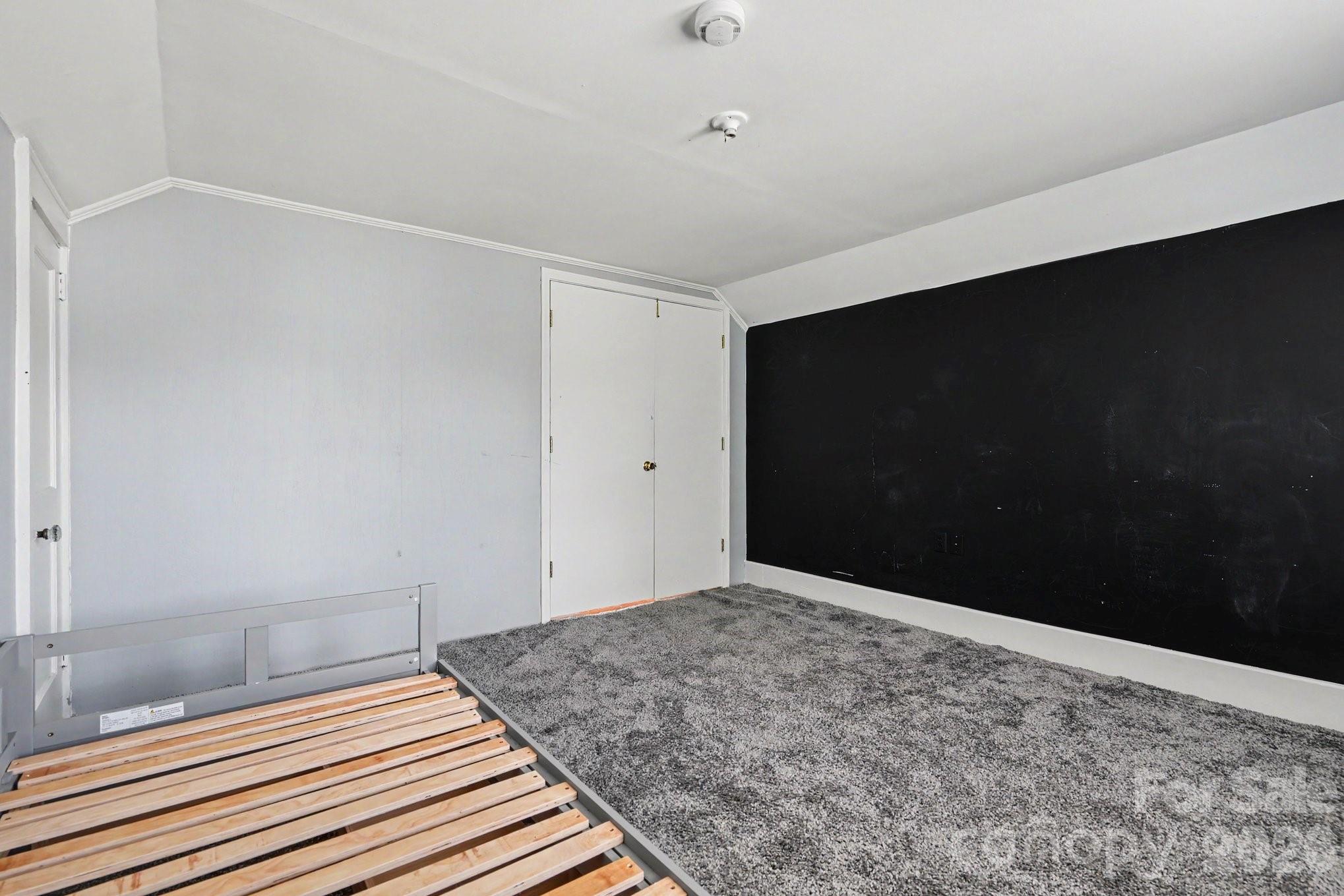 24359 Ridgecrest Road Locust, NC 28097 - Photo 18 of 26 a bedroom with a bed and a wall painting