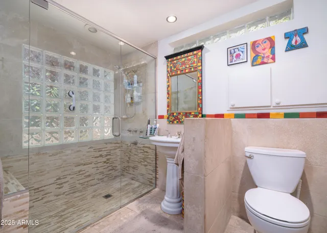 a bedroom with bed and a large mirror