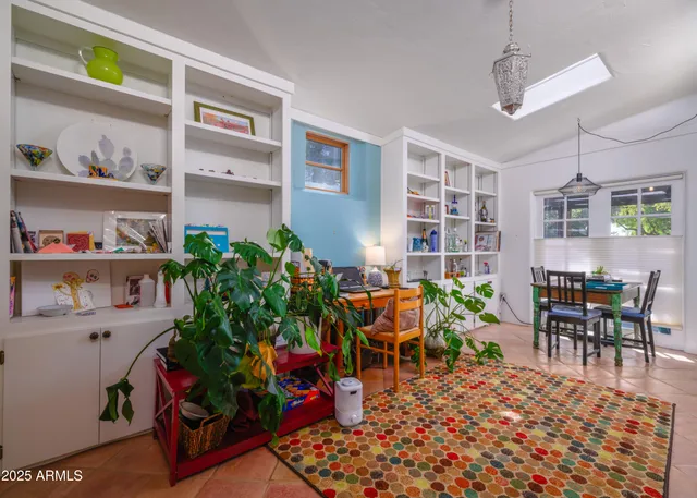 a living room with dining room and wooden floor