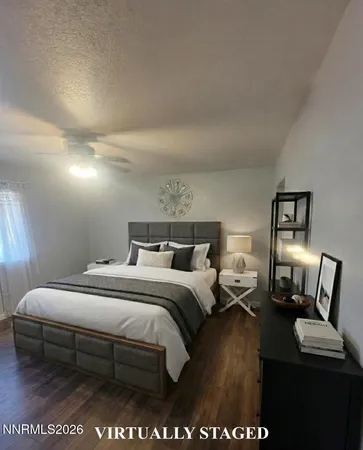 a bedroom with a bed a mirror and lamp