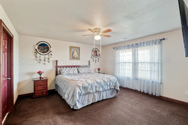a spacious bedroom with a bed and a chandelier