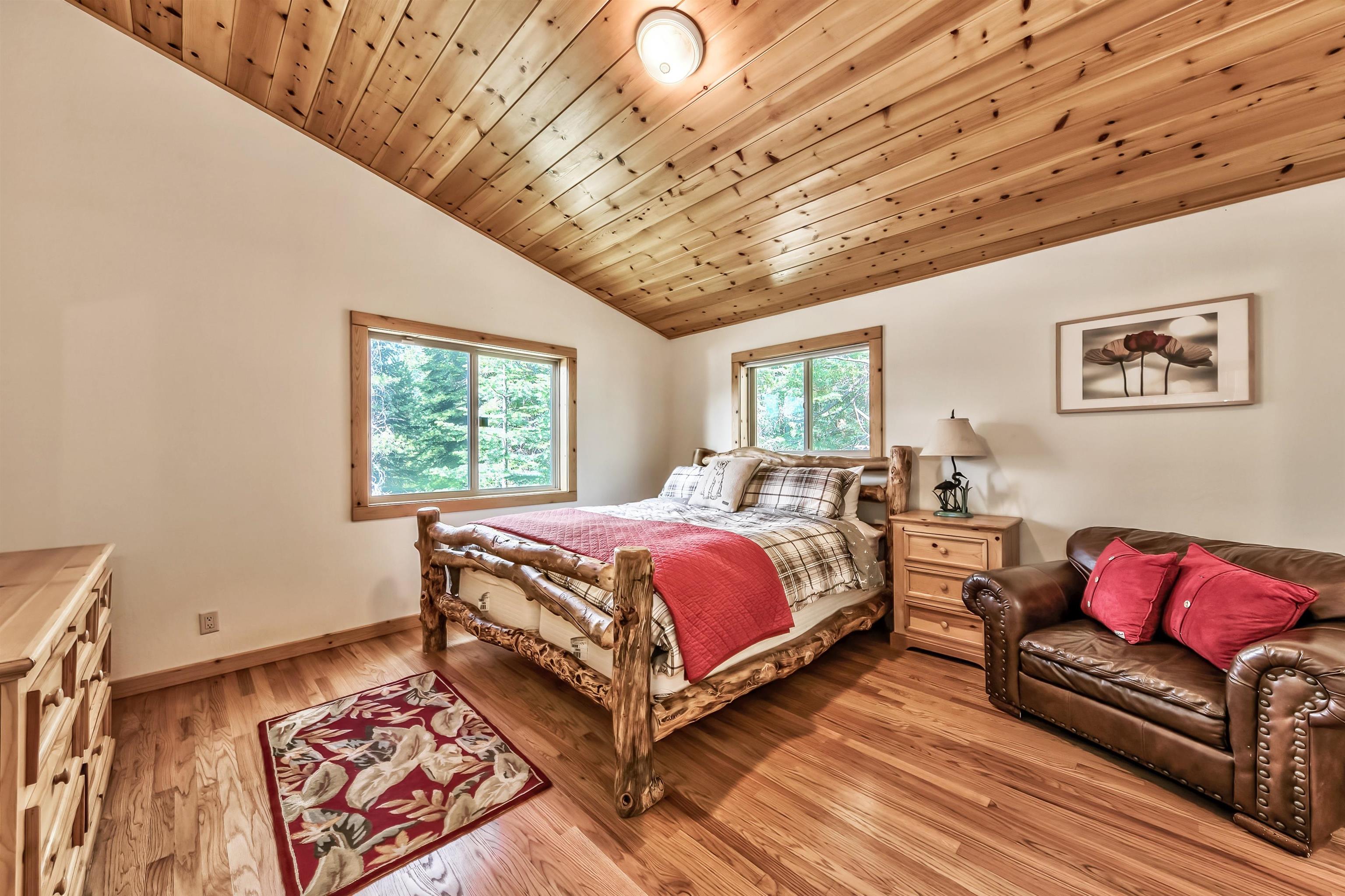 10488 Heather Road Truckee, CA 96161 - Photo 15 of 21 a spacious bedroom with a bed and a couch