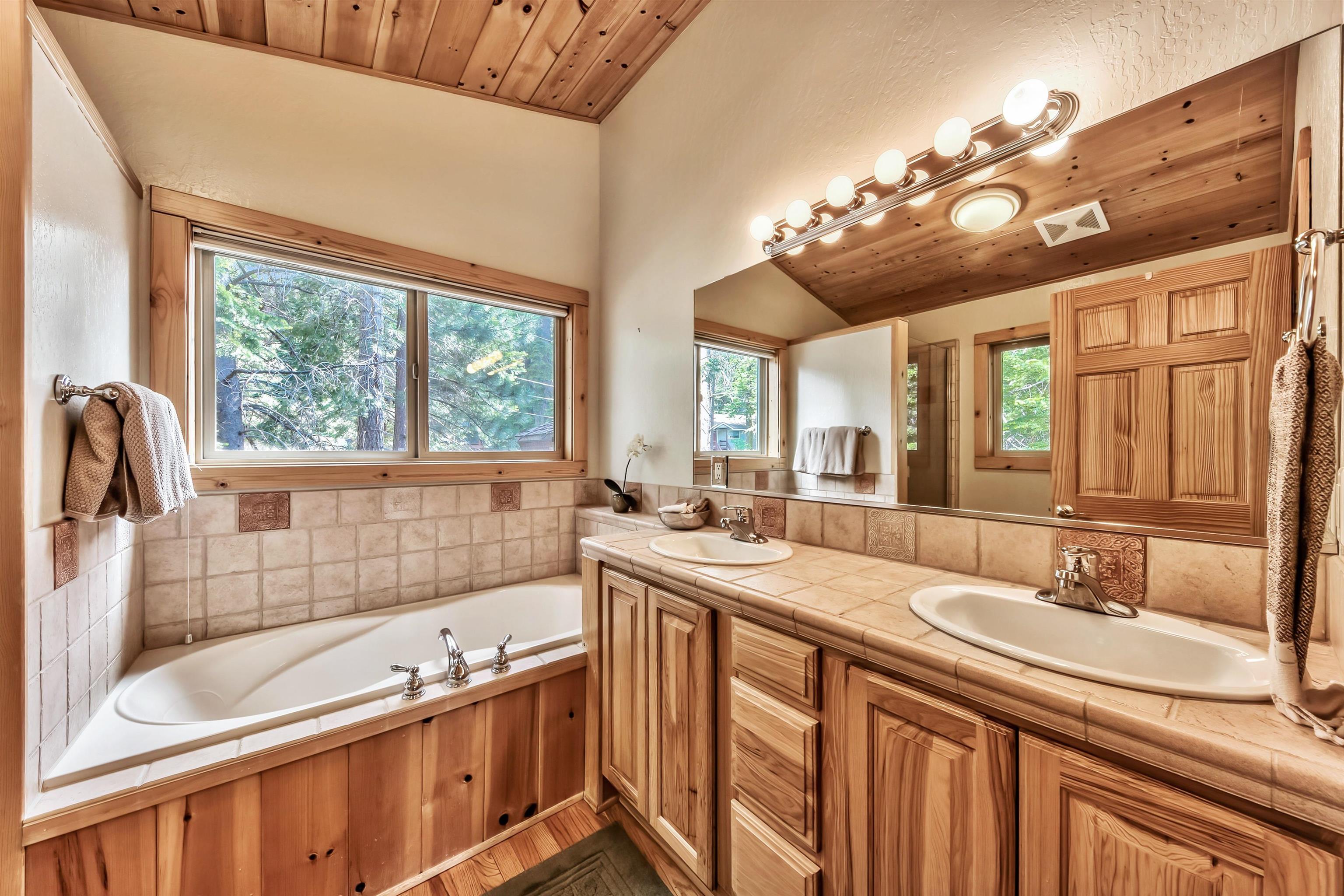 10488 Heather Road Truckee, CA 96161 - Photo 16 of 21 a bathroom with a tub sink and mirror