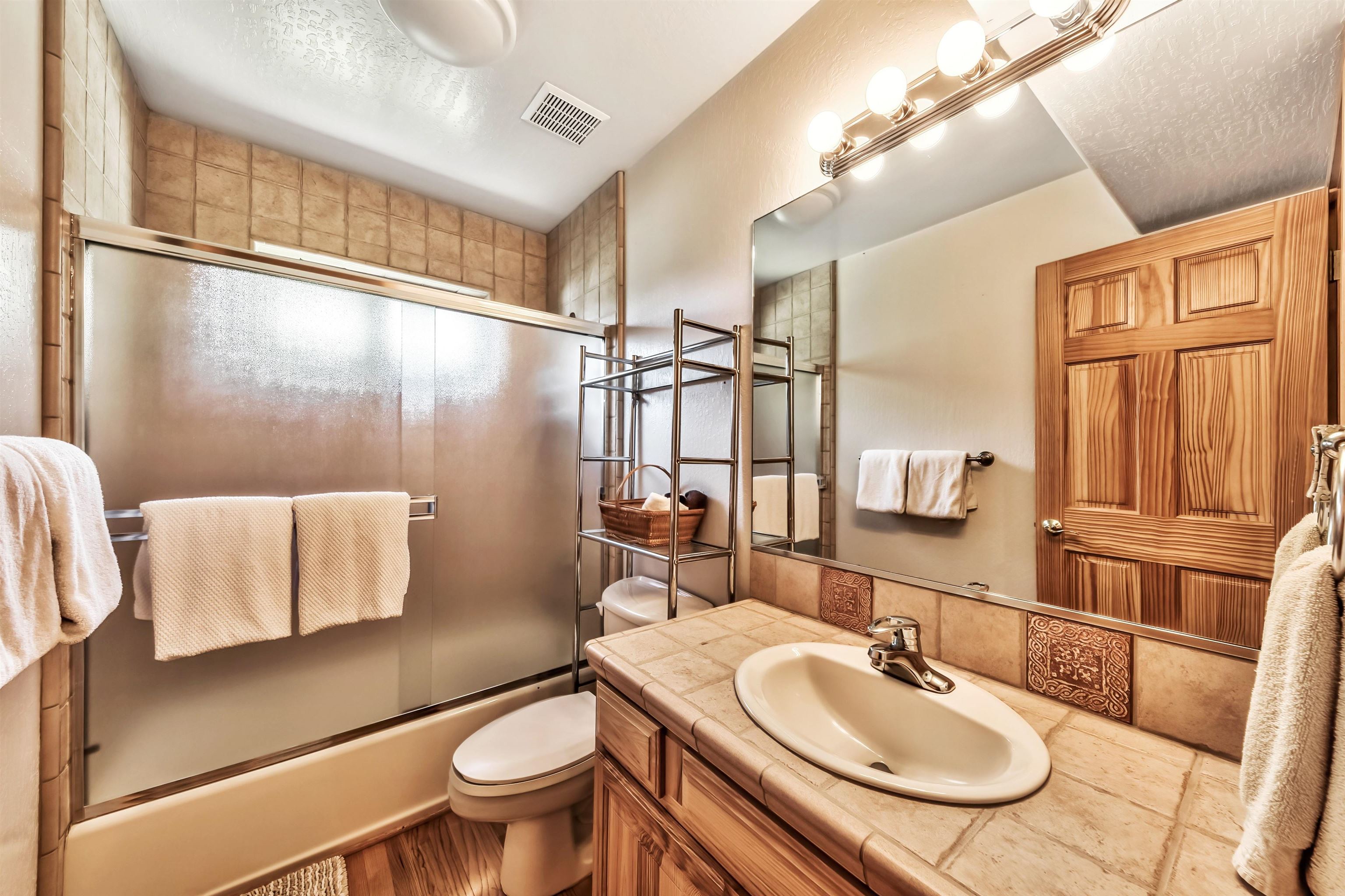 10488 Heather Road Truckee, CA 96161 - Photo 20 of 21 a bathroom with a granite countertop sink toilet a mirror and shower
