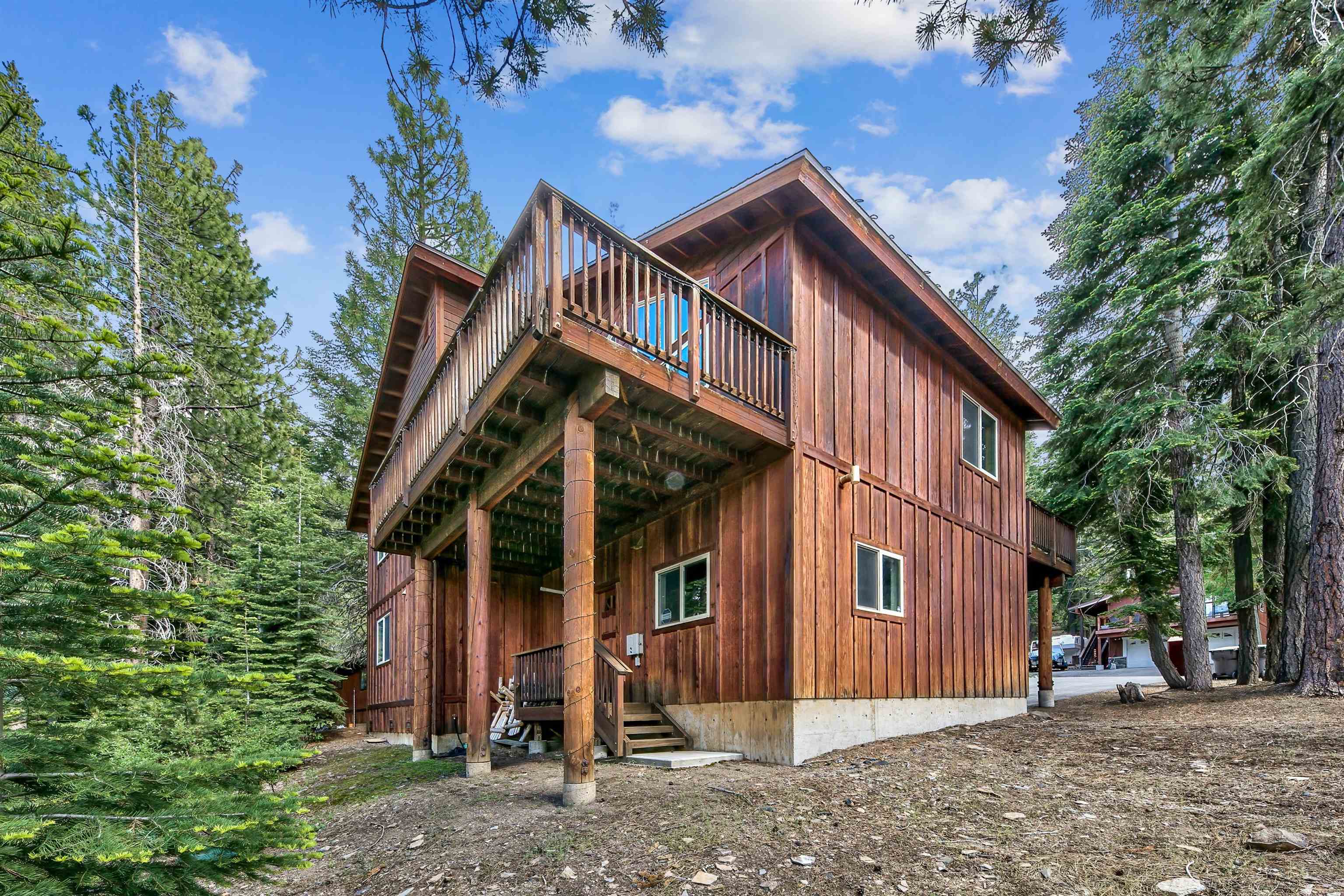 10488 Heather Road Truckee, CA 96161 - Photo 3 of 21 a view of a house that has a small yard and large trees