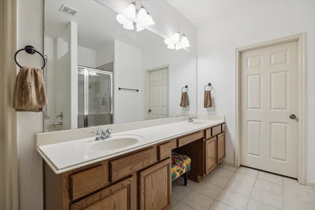 a bathroom with a sink a mirror and a shower