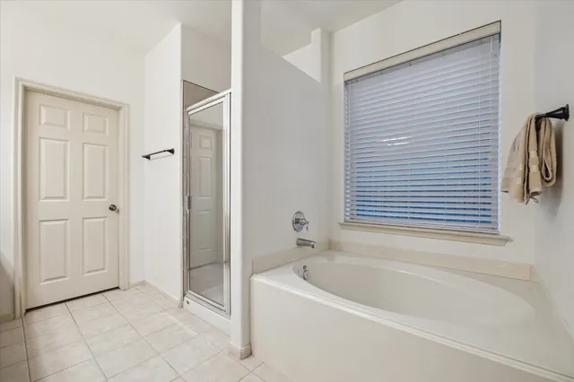 a bathroom with a bathtub and a shower