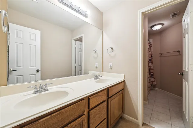 a bathroom with a sink double vanity and a mirror