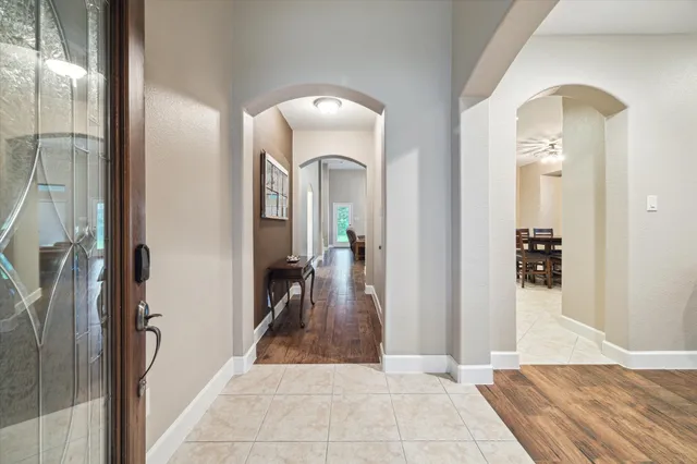 a view of a hallway with wooden floor