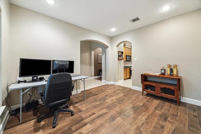 a view of a workspace with furniture and a window