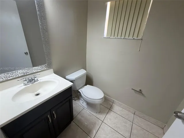 a bathroom with a sink toilet and mirror