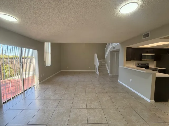 a view of a kitchen with a sink and cabinets
