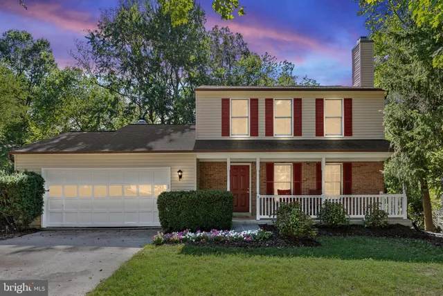 a front view of a house with a garden and plants