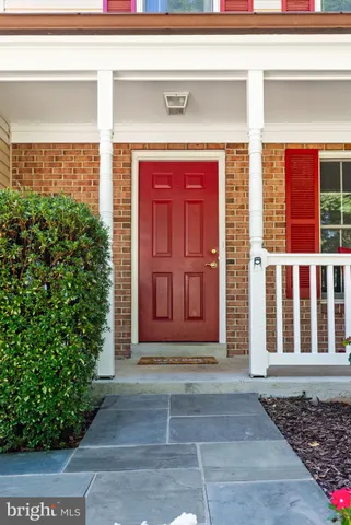 a kitchen with a refrigerator a stove a sink dishwasher with a dining table and chair