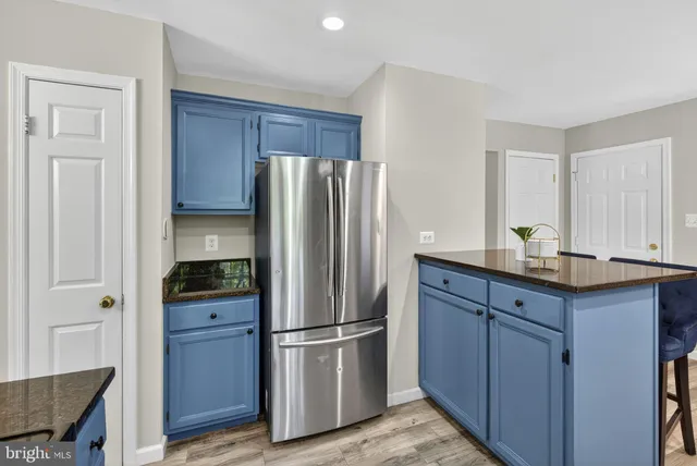 a bedroom with a bed ceiling fan and a window