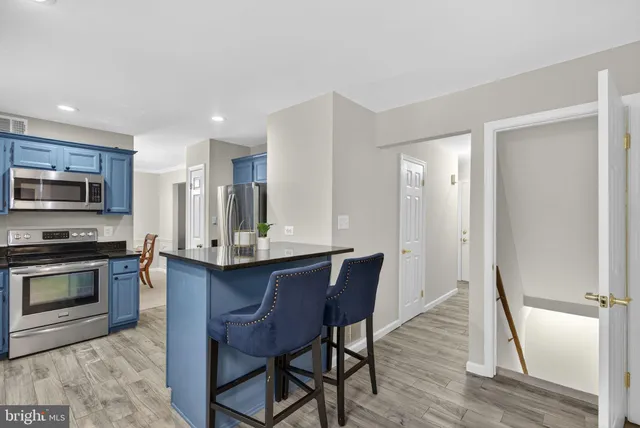 a large bed sitting in a bedroom next to a window