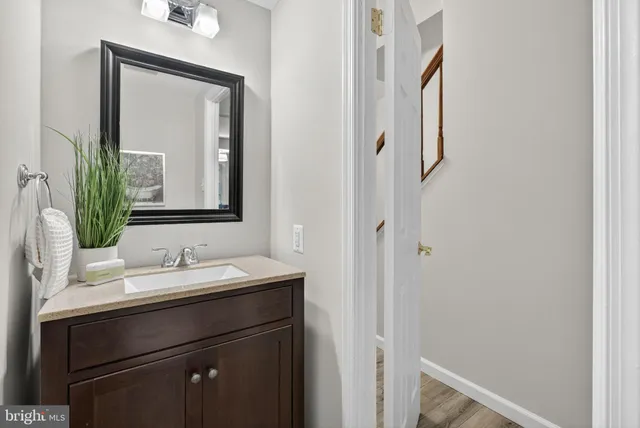 a bathroom with a shower sink vanity mirror and toilet