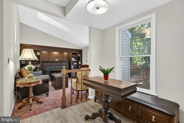 a bedroom with a bed a chandelier and a window