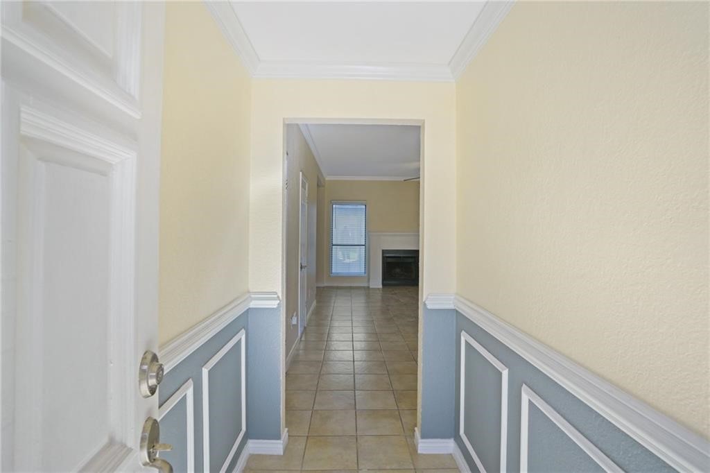 2713 St Joseph Street Corpus Christi, TX 78418 - Photo 2 of 17 a view of a hallway with wooden floor and a bathroom