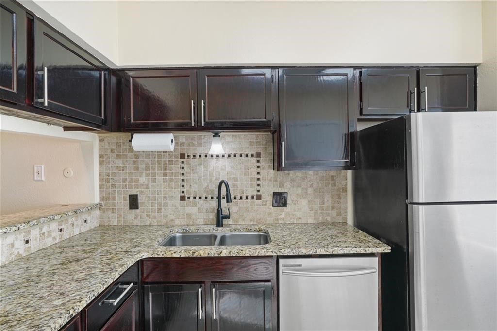 2713 St Joseph Street Corpus Christi, TX 78418 - Photo 7 of 17 a kitchen with a refrigerator and a sink