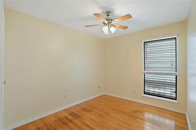 a view of a room with a ceiling fan and a window
