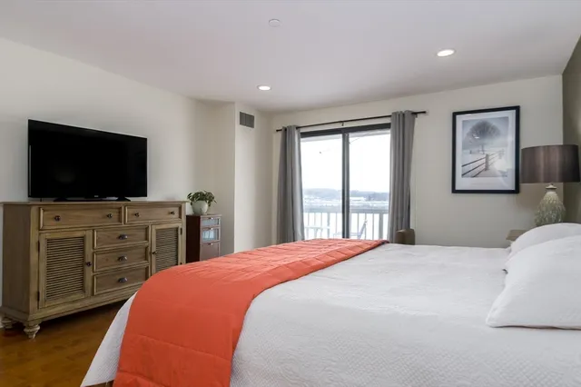 a bedroom with a bed and a flat screen tv in it