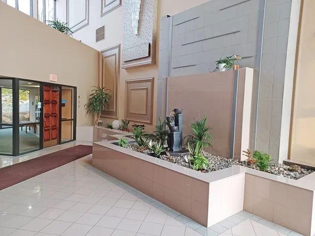 a living room filled with furniture and a potted plant