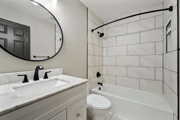 a bathroom with a sink a toilet and a mirror