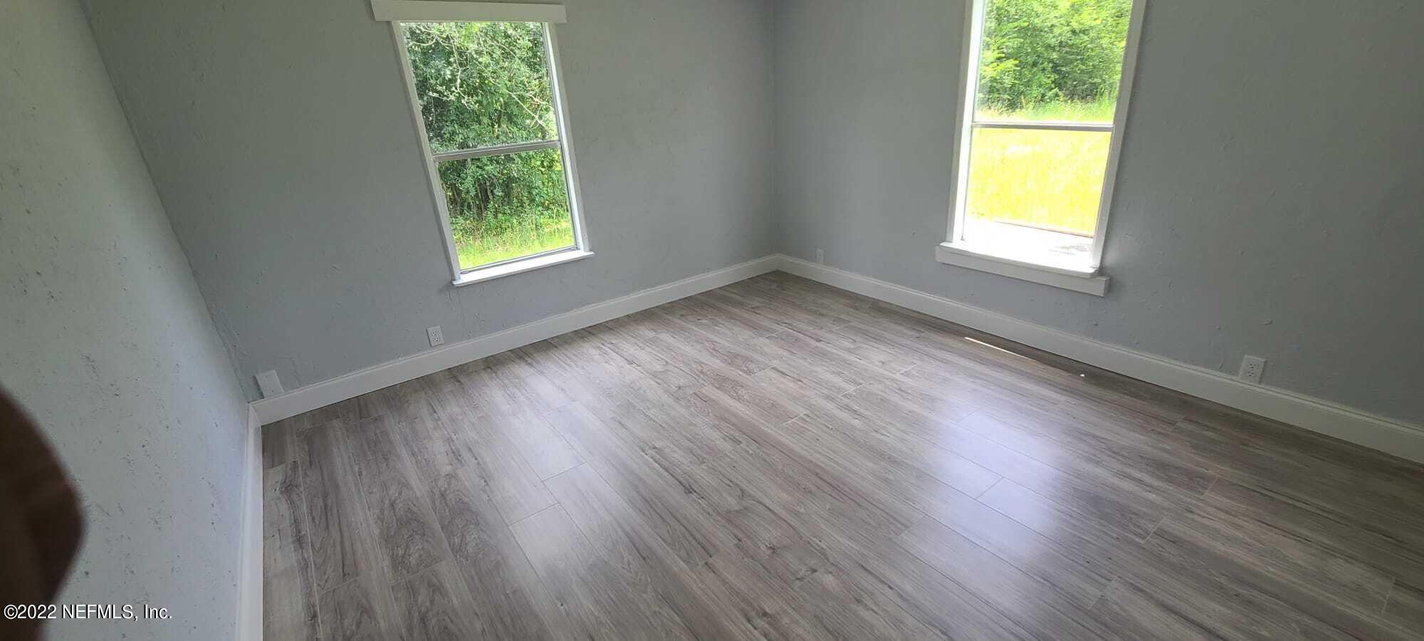 9645 Luther Beck Road Hastings, FL 32145 - Photo 16 of 17 a view of an empty room with wooden floor and a window