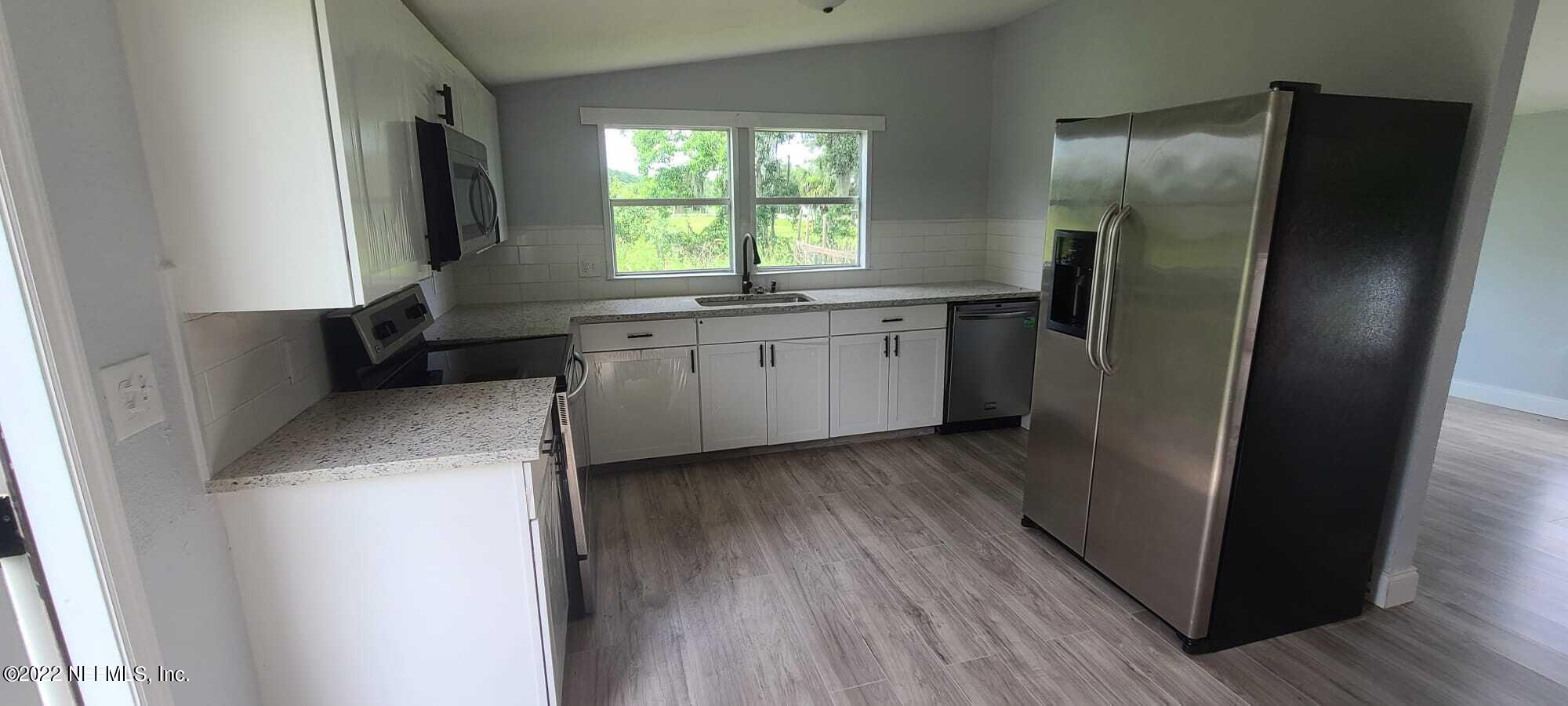 9645 Luther Beck Road Hastings, FL 32145 - Photo 4 of 17 a kitchen with refrigerator and window