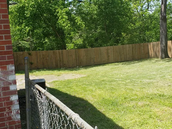 a view of swimming pool with wooden fence